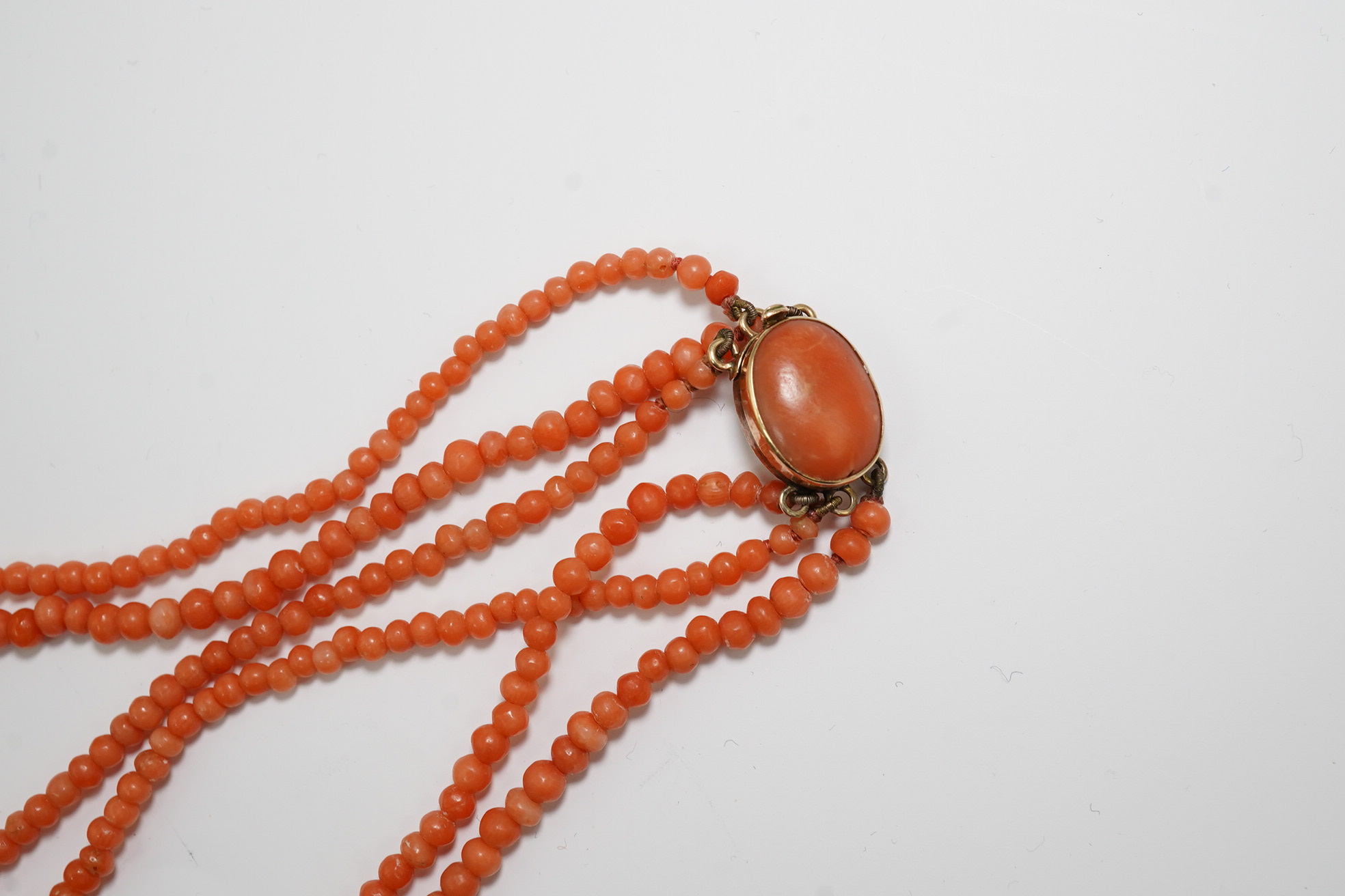 A late Victorian triple strand coral bead necklace